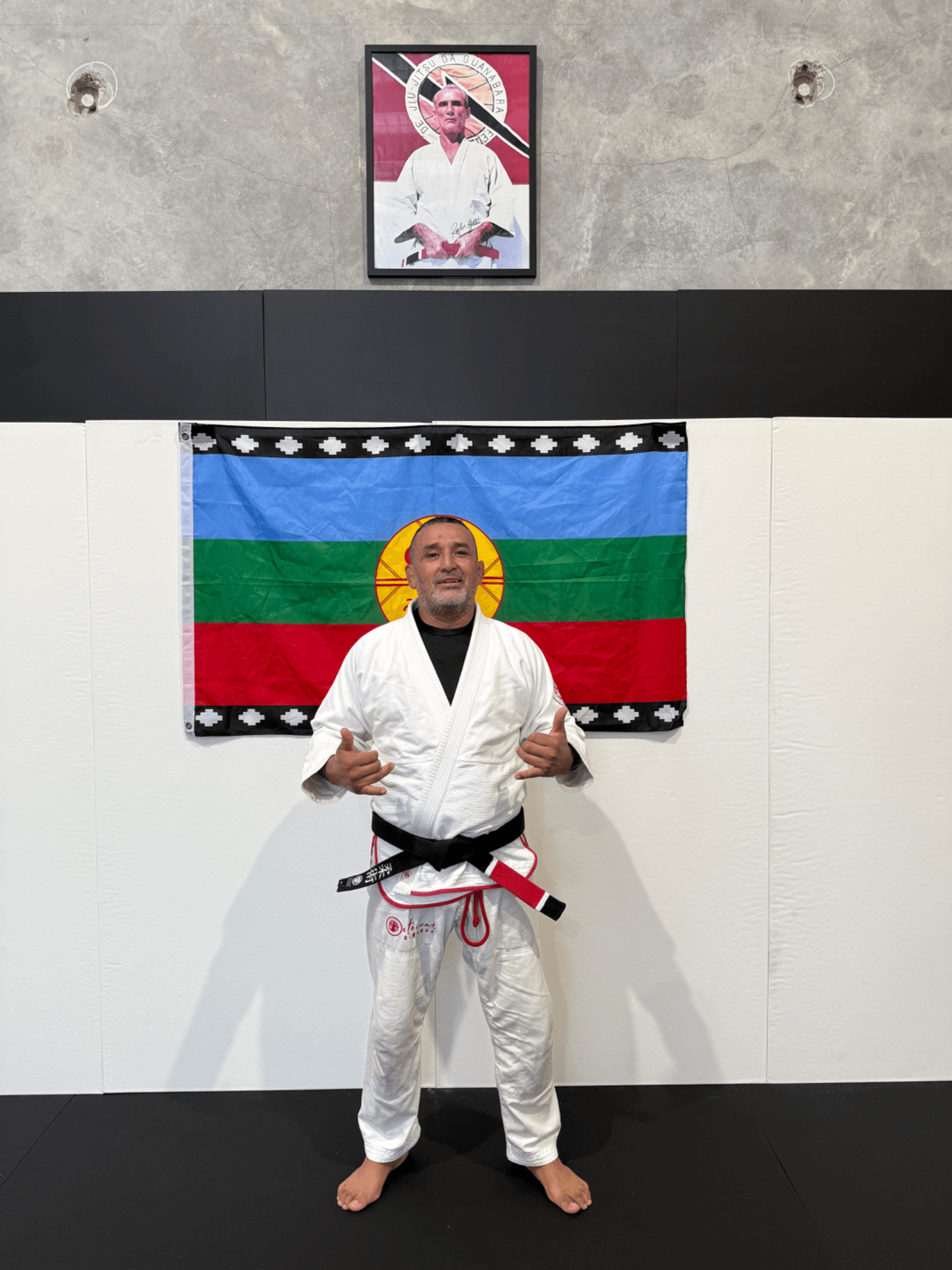 Professor Rene in front of the Mapuche flag at the academy
