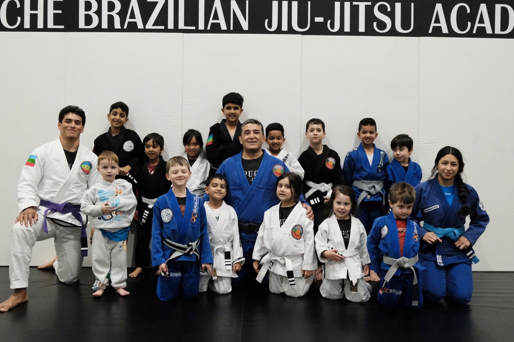 The kids classes together on the mat with their instructors