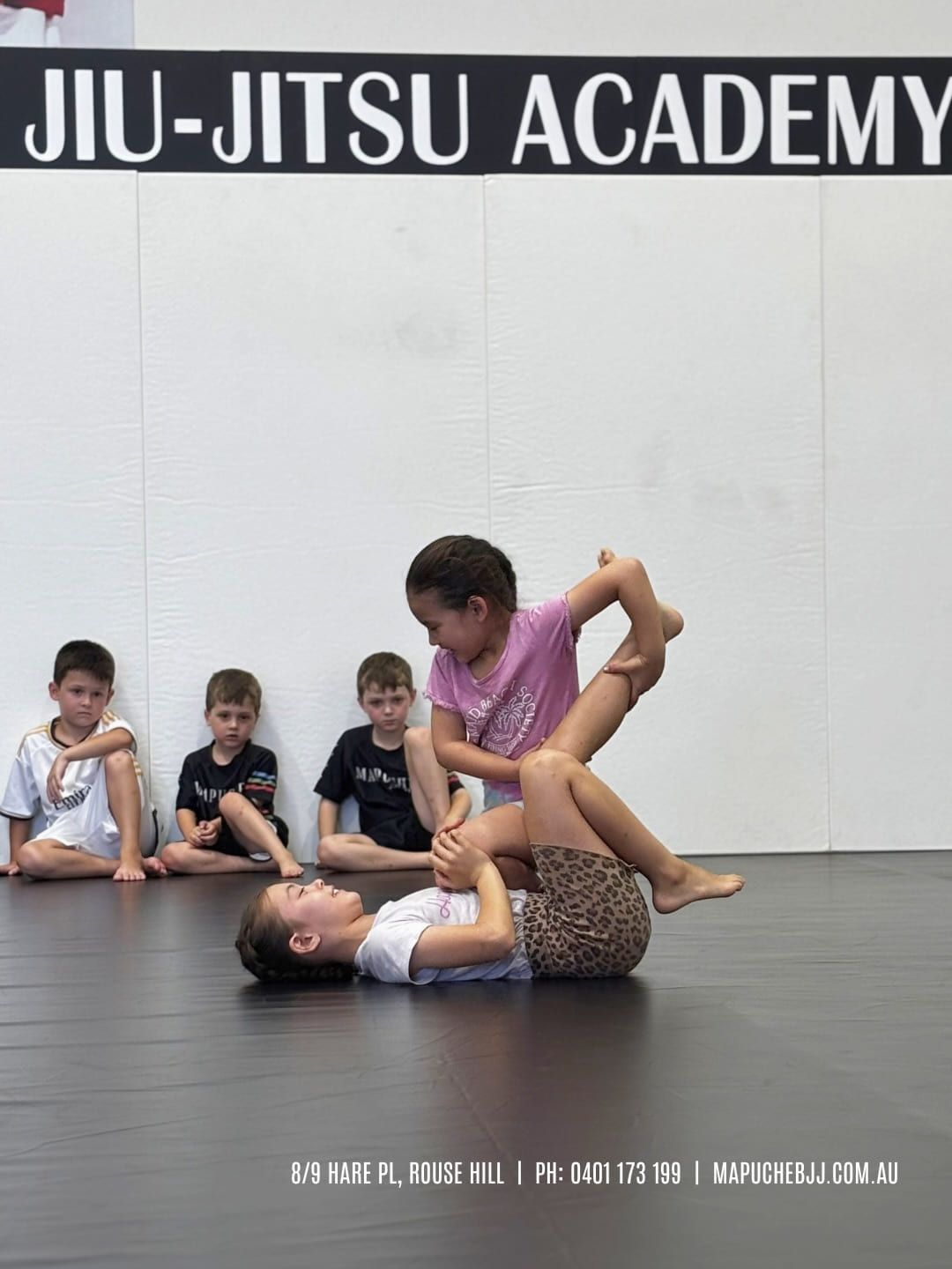 A young student practising a technique with a partner